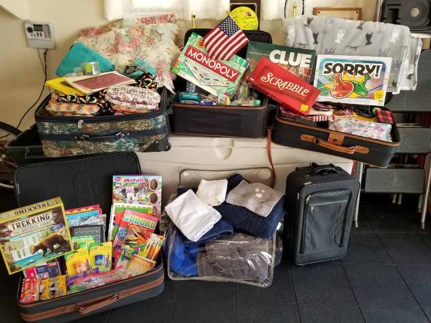 Photo of children's games, blankets, books, personal care items, luggage