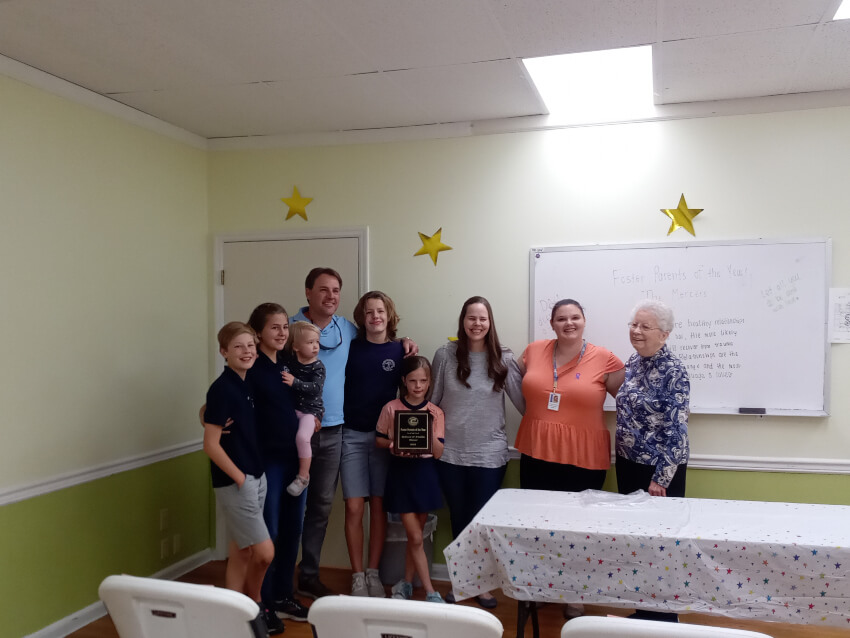 Rebecca and Freddier Mercer, stand with their five children