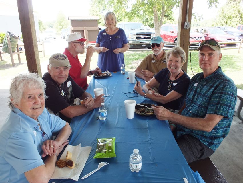 Seven New Bern Civitan Club members sitting at picnic table