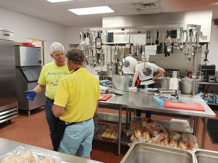 two men talking in kitchen