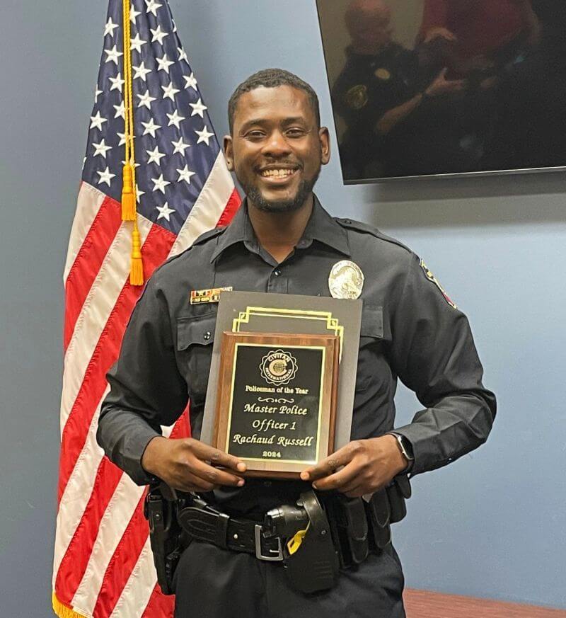 Officer Rachaud Russell holding Civitan award