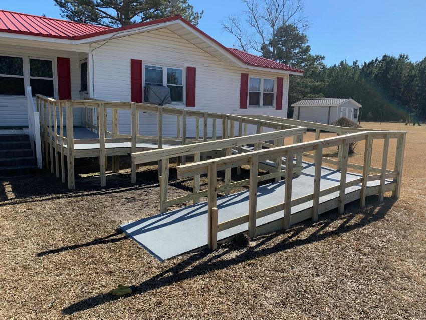 Wood handicap ramp in front of small white house