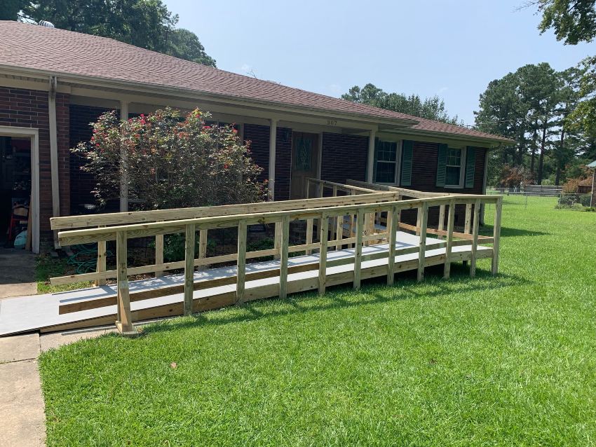 Handicap ramp to front door of brick ranch house