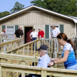 Veteran in wheelchair using new ramp to his house